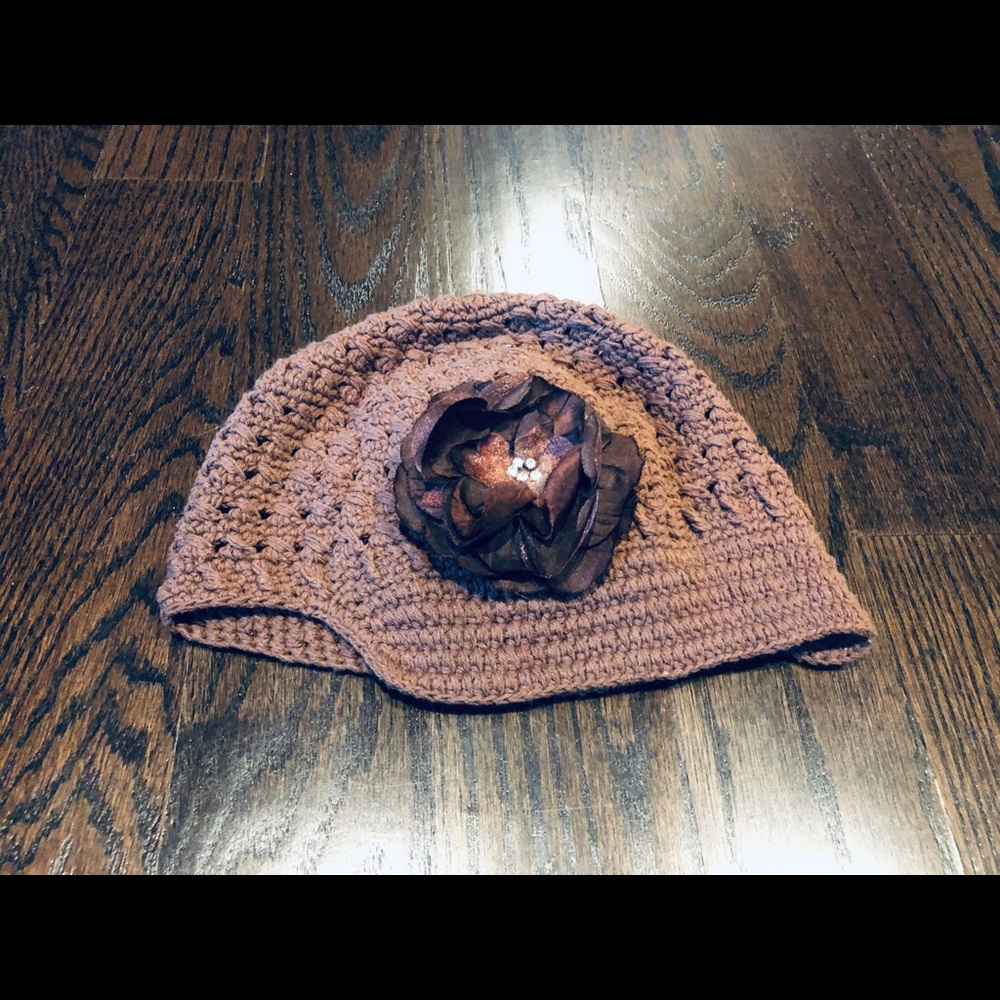Brown cap style hat with flower
